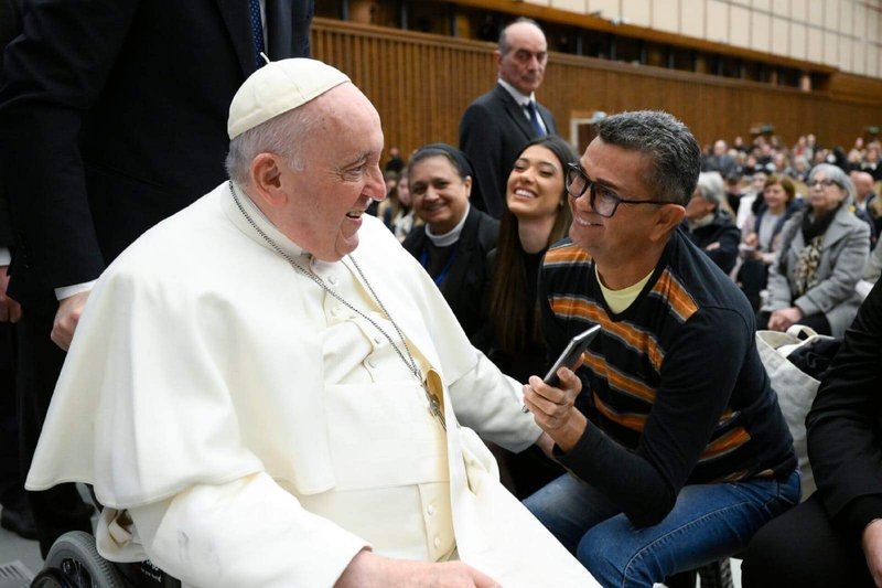 Faustino Pinto, who has been cured of leprosy, with Pope Francis.jpg