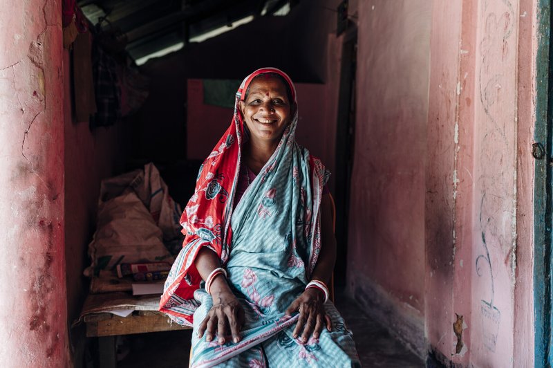 Aloka, a woman affected by leprosy, sitting in her home in Bangaldesh.