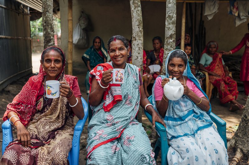 Women affected by leprosy enjoying tea in Bangladesh.