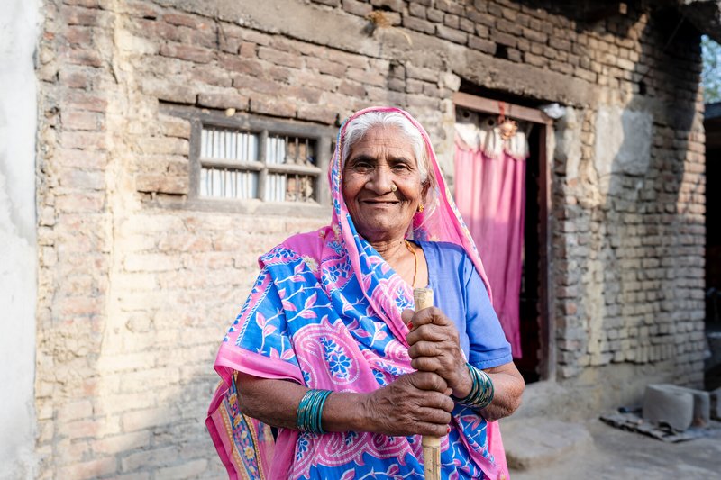 Dhanmati, a woman affected by leprosy from Nepal, stands outside her house.