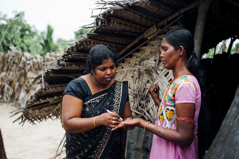 Deborah checks Priya for signs of leprosy